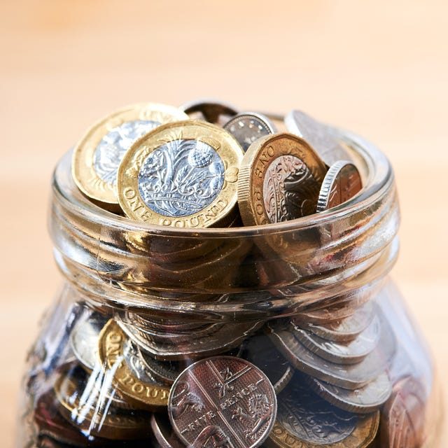 Glass jar full of UK pound coins representing savings growth