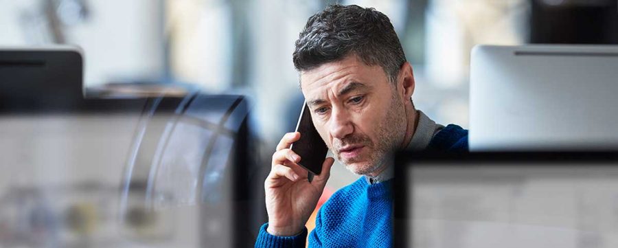 Person on phone reporting identity theft to their bank